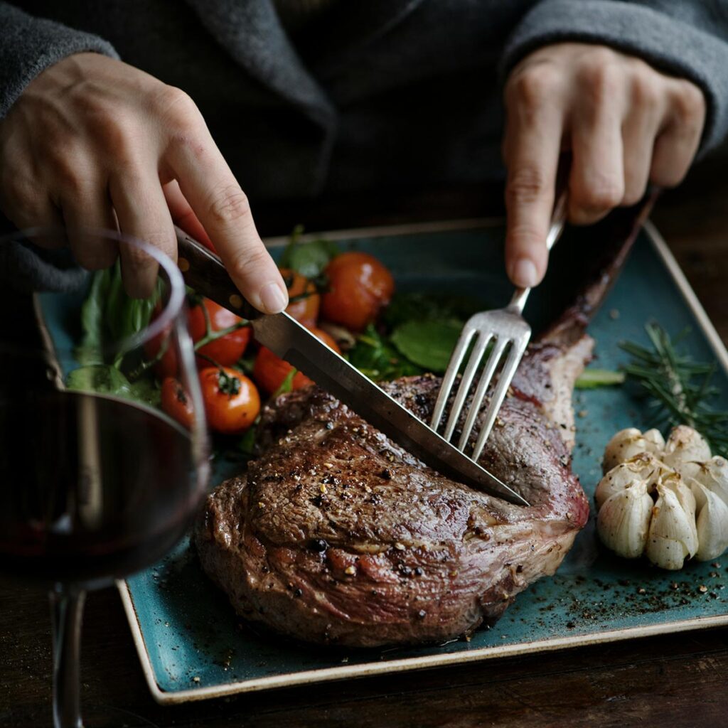 grilled steak, garlic, tomatoes, and wine